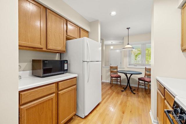 358 Bristol Ln, Fox River Grove, IL 60021 - kitchen featuring freestanding refrigerator, light wood-style floors, black microwave, light countertops, and stove
