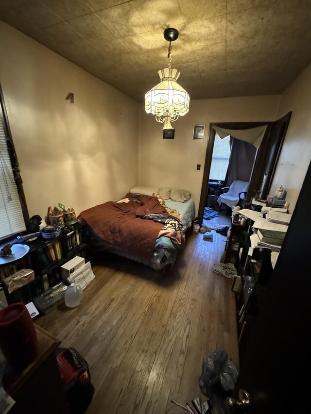 7145 S Seeley Ave, Chicago, IL 60636 - bedroom featuring wood-type flooring and a chandelier