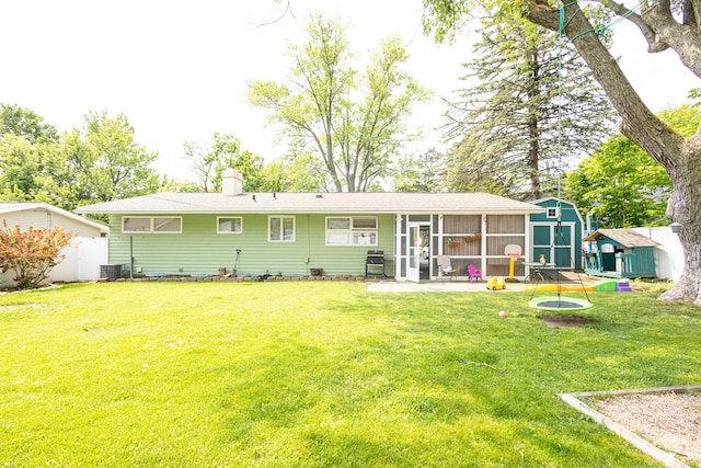 309 River Dr, Dekalb, IL 60115 - back of house with a sunroom and a chimney