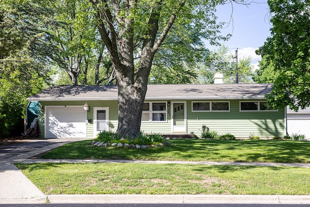 309 River Dr, Dekalb, IL 60115 - single story home with a garage, asphalt driveway, a front yard, and a chimney