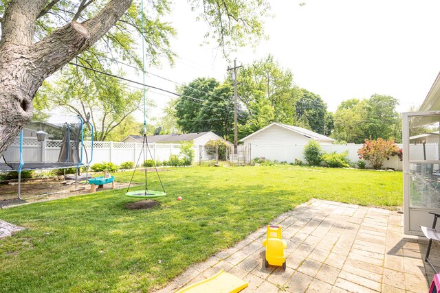 309 River Dr, Dekalb, IL 60115 - view of yard with a trampoline and a patio