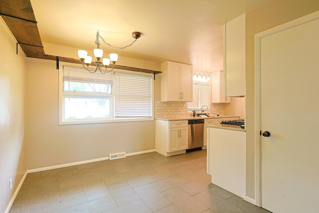 309 River Dr, Dekalb, IL 60115 - kitchen with stainless steel appliances, plenty of natural light, a chandelier, and white cabinetry