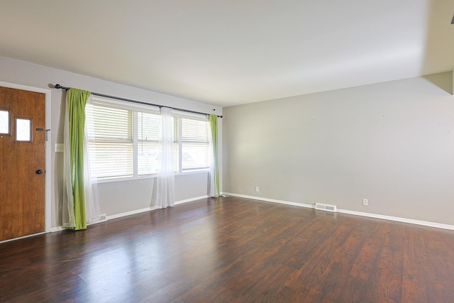 309 River Dr, Dekalb, IL 60115 - spare room featuring plenty of natural light, wood finished floors, and baseboards