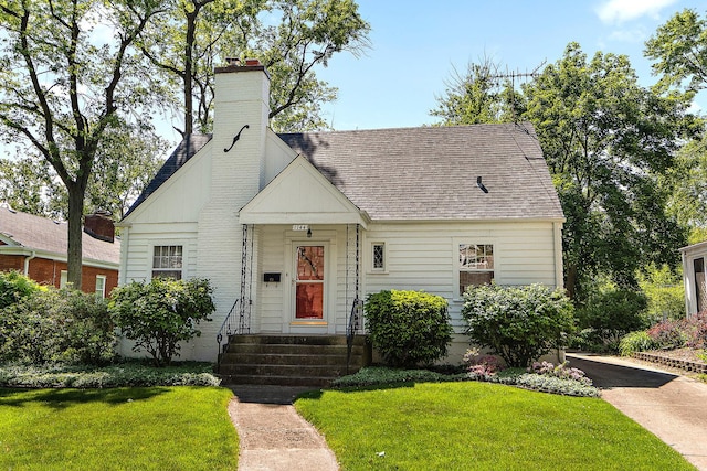 1144 Leavitt Ave, Flossmoor, IL 60422 - view of front of home with a front yard, a chimney, and a shingled roof
