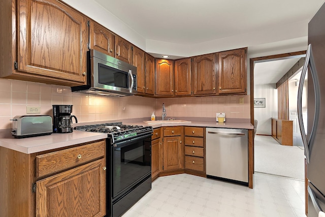 1144 Leavitt Ave, Flossmoor, IL 60422 - kitchen featuring appliances with stainless steel finishes, a sink, light floors, light countertops, and backsplash