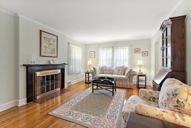 1144 Leavitt Ave, Flossmoor, IL 60422 - living area with crown molding, wood finished floors, a fireplace with flush hearth, and baseboards