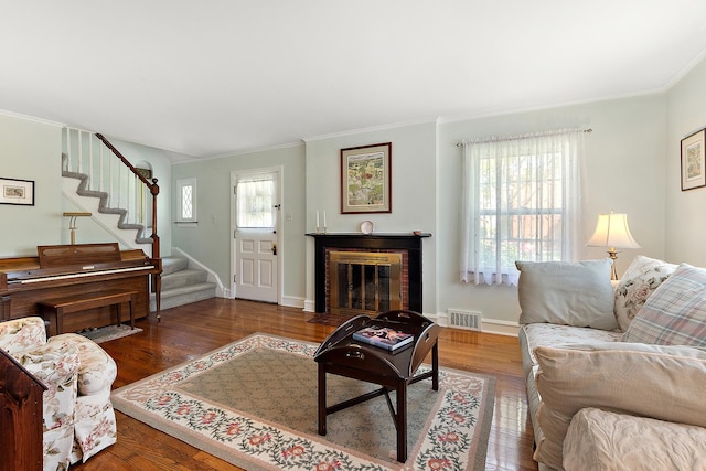 1144 Leavitt Ave, Flossmoor, IL 60422 - living area with ornamental molding, stairway, wood finished floors, a fireplace with flush hearth, and baseboards