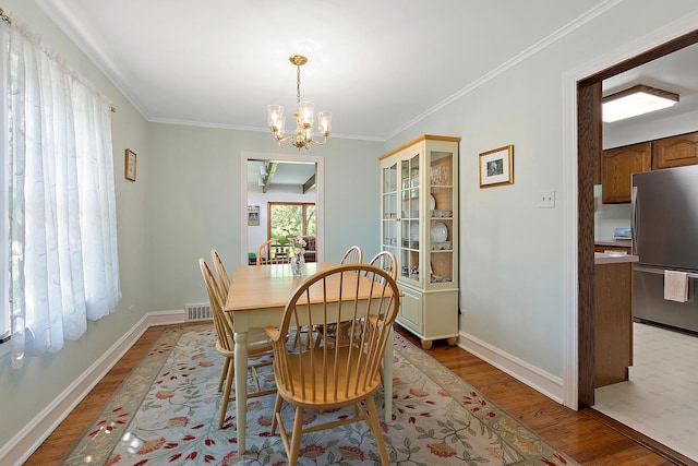1144 Leavitt Ave, Flossmoor, IL 60422 - dining area with light wood-style floors, a chandelier, ornamental molding, and baseboards