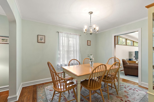 1144 Leavitt Ave, Flossmoor, IL 60422 - dining room with healthy amount of natural light, arched walkways, crown molding, wood finished floors, and a chandelier