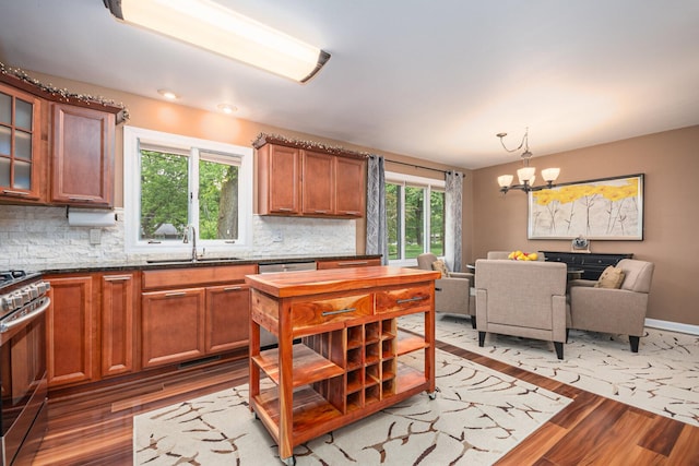 831 W Marywood Ave, Aurora, IL 60505 - kitchen with a sink, appliances with stainless steel finishes, light wood-style flooring, a chandelier, and backsplash