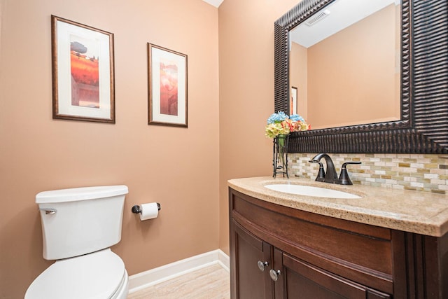 831 W Marywood Ave, Aurora, IL 60505 - bathroom with toilet, vanity, baseboards, and backsplash