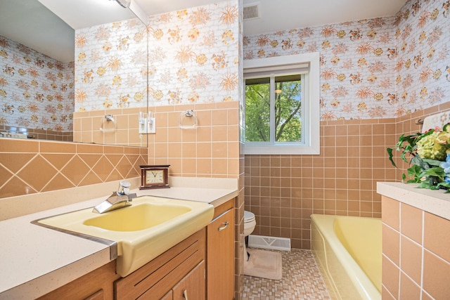 831 W Marywood Ave, Aurora, IL 60505 - bathroom featuring wallpapered walls, vanity, tile walls, toilet, and a bath