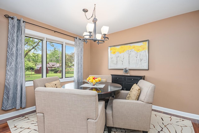 831 W Marywood Ave, Aurora, IL 60505 - dining space featuring a chandelier, baseboards, and wood finished floors