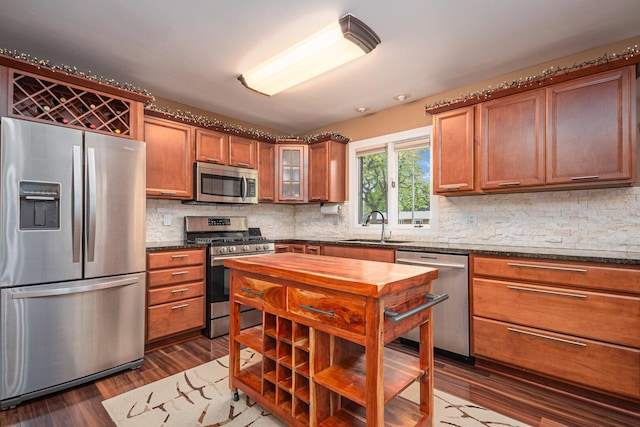 831 W Marywood Ave, Aurora, IL 60505 - kitchen featuring appliances with stainless steel finishes, a sink, backsplash, dark wood-type flooring, and glass insert cabinets