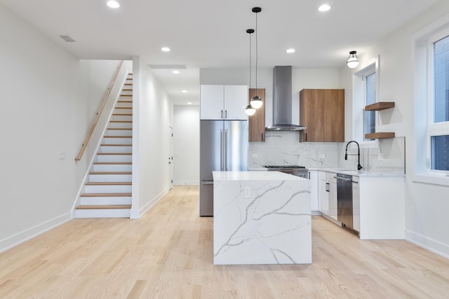 2417 W Walton St Unit 3, Chicago, IL 60622 - kitchen with wall chimney exhaust hood, appliances with stainless steel finishes, modern cabinets, open shelves, and a kitchen island