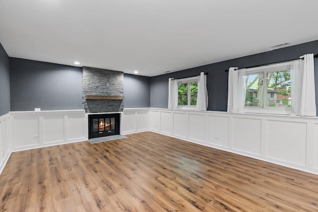 5S542 Tartan Ln, Naperville, IL 60563 - unfurnished living room featuring a decorative wall, wood finished floors, a fireplace, wainscoting, and recessed lighting