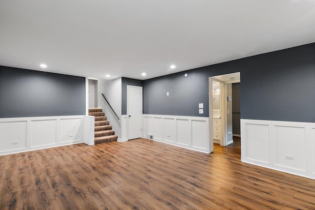 5S542 Tartan Ln, Naperville, IL 60563 - basement featuring a decorative wall, wood finished floors, stairway, wainscoting, and recessed lighting