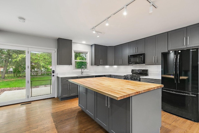 5S542 Tartan Ln, Naperville, IL 60563 - kitchen featuring black appliances, wooden counters, gray cabinetry, rail lighting, and tasteful backsplash