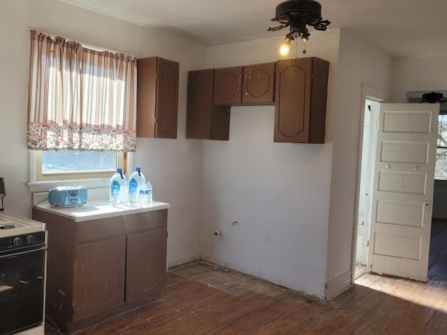 8405 S Baltimore Ave, Chicago, IL 60617 - kitchen featuring light wood-type flooring, black / electric stove, ceiling fan, and light countertops