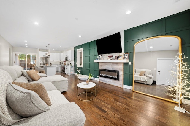 7230 W Belden Ave Unit 1, Elmwood Park, IL 60707 - living area featuring a glass covered fireplace, dark wood-style flooring, a decorative wall, and recessed lighting