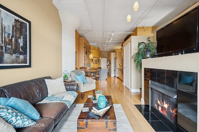 1530 S State St Unit 408, Chicago, IL 60605 - living area with wood finished floors, a tile fireplace, and rail lighting