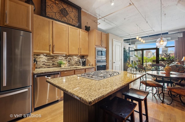 1530 S State St Unit 408, Chicago, IL 60605 - kitchen with appliances with stainless steel finishes, a sink, rail lighting, light wood-style flooring, and a kitchen island