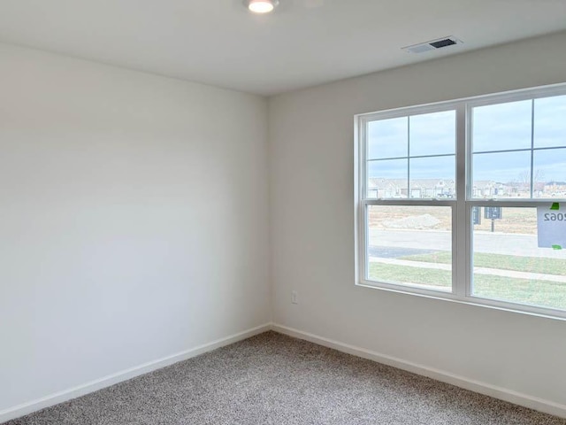 2276 Elderberry Ct, Wonder Lake, IL 60097 - empty room with plenty of natural light, baseboards, and light colored carpet