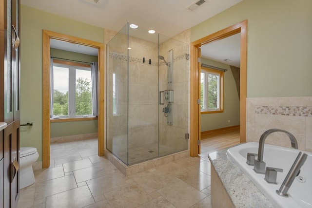 415 Honey Locust Ln, Willowbrook, IL 60527 - full bathroom featuring a stall shower, baseboards, toilet, and a bath