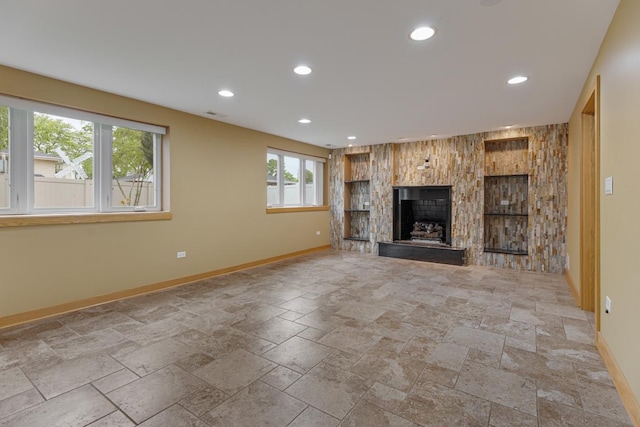415 Honey Locust Ln, Willowbrook, IL 60527 - unfurnished living room featuring baseboards, stone tile floors, recessed lighting, and a fireplace