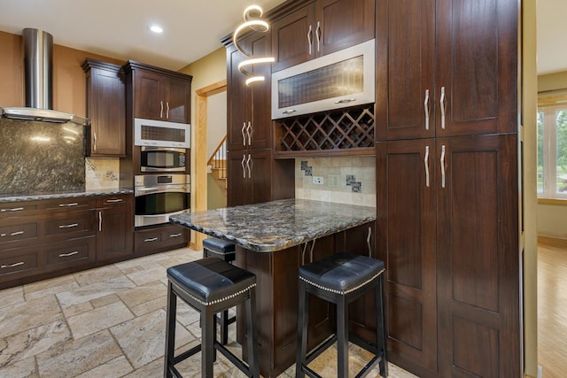 415 Honey Locust Ln, Willowbrook, IL 60527 - kitchen with stainless steel oven, wall chimney range hood, stone tile flooring, dark stone countertops, and decorative backsplash