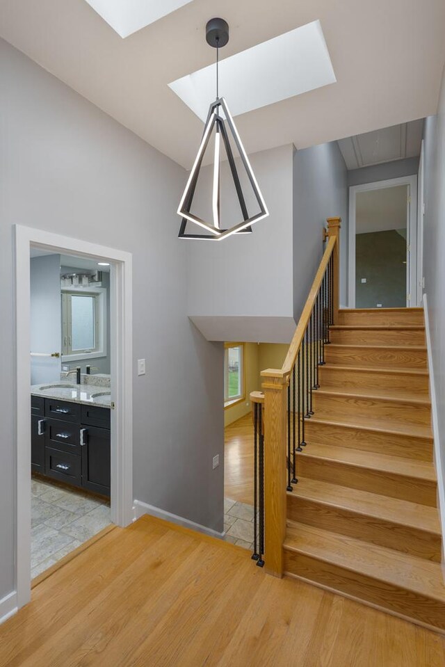 415 Honey Locust Ln, Willowbrook, IL 60527 - stairs with a skylight, wood finished floors, and baseboards