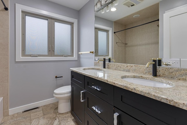415 Honey Locust Ln, Willowbrook, IL 60527 - bathroom featuring toilet, baseboards, double vanity, and stone finish flooring