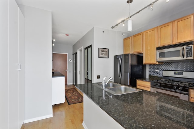 210 S Desplaines St Unit 706, Chicago, IL 60661 - kitchen featuring appliances with stainless steel finishes, light brown cabinets, backsplash, light wood-style flooring, and dark stone counters