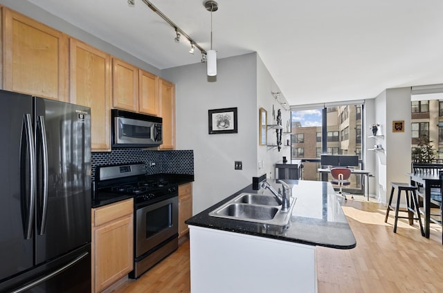 210 S Desplaines St Unit 706, Chicago, IL 60661 - kitchen with appliances with stainless steel finishes, light brown cabinets, light wood-style flooring, decorative backsplash, and dark countertops