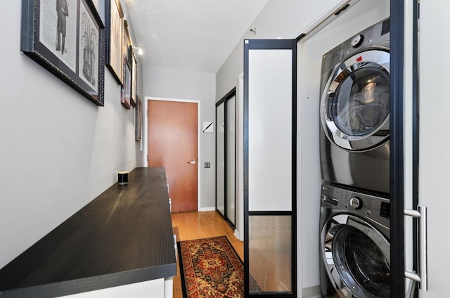 210 S Desplaines St Unit 706, Chicago, IL 60661 - laundry area featuring stacked washer and clothes dryer and light wood finished floors