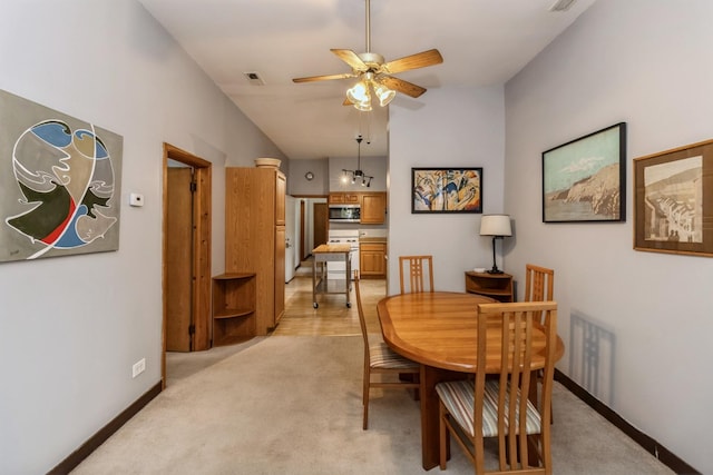 4419 S Wallace St, Chicago, IL 60609 - dining area with vaulted ceiling, ceiling fan, light colored carpet, and baseboards
