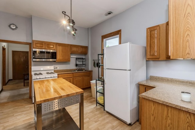 4419 S Wallace St, Chicago, IL 60609 - kitchen with white appliances, a sink, light wood-style floors, and light countertops