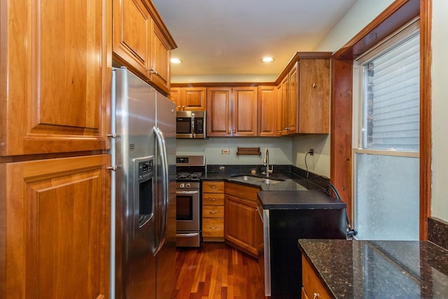 4419 S Wallace St, Chicago, IL 60609 - kitchen featuring stainless steel appliances, a sink, brown cabinetry, dark wood-style flooring, and recessed lighting