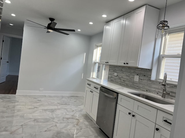 kitchen with stainless steel dishwasher, a sink, ceiling fan, recessed lighting, and baseboards