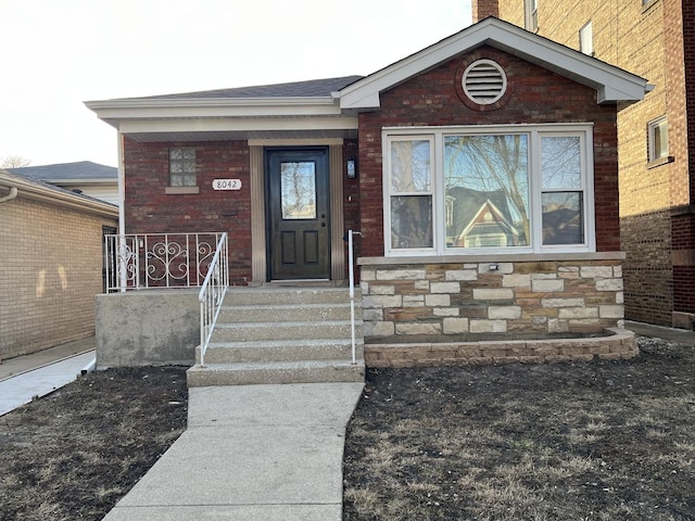 property entrance featuring a porch and stone siding