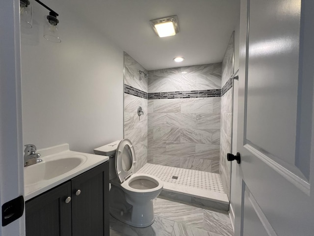 full bathroom featuring a stall shower, toilet, vanity, recessed lighting, and marble finish floors