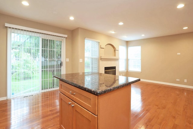 1437 Sturgeon Bay Ct, Schaumburg, IL 60173 - kitchen featuring light wood finished floors, open floor plan, baseboards, dark stone countertops, and recessed lighting