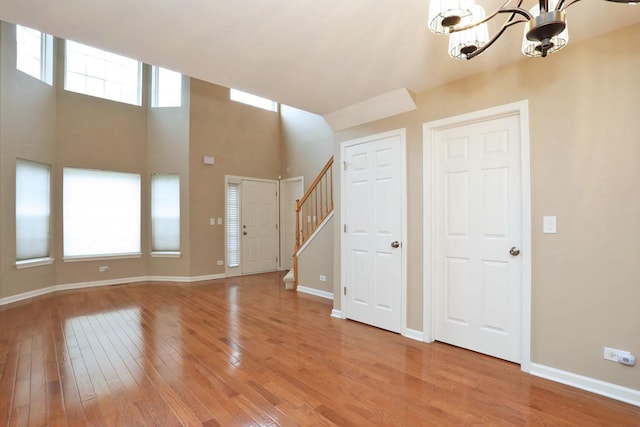 1437 Sturgeon Bay Ct, Schaumburg, IL 60173 - foyer featuring light wood-style floors, a chandelier, stairs, and baseboards