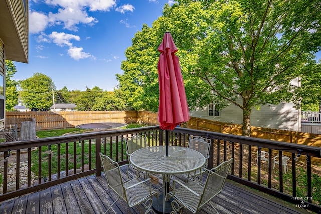 1101 Paul Ct, Fox River Grove, IL 60021 - wooden deck with a fenced backyard, a trampoline, and outdoor dining area