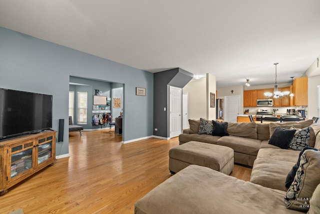 1101 Paul Ct, Fox River Grove, IL 60021 - living room with a chandelier, light wood-type flooring, and baseboards