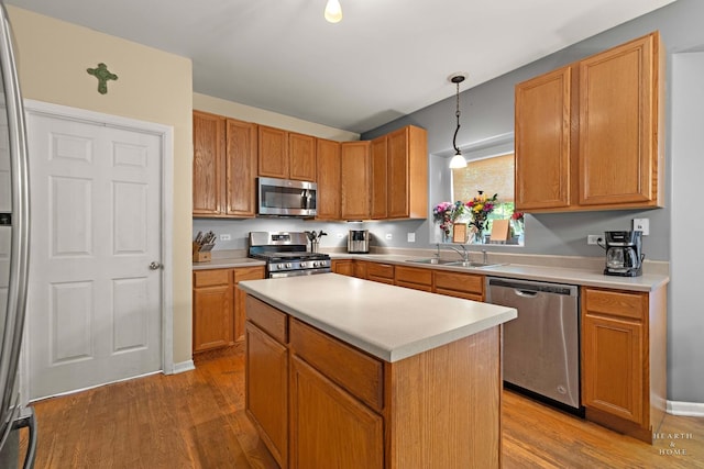 1101 Paul Ct, Fox River Grove, IL 60021 - kitchen featuring stainless steel appliances, a sink, light wood-type flooring, and light countertops