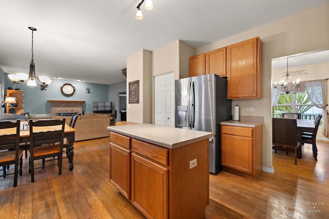 1101 Paul Ct, Fox River Grove, IL 60021 - kitchen with a chandelier, stainless steel fridge, wood finished floors, open floor plan, and light countertops