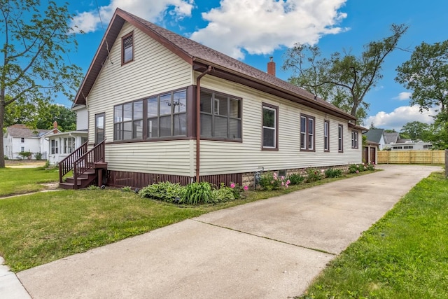 1006 W 1st St, Dixon, IL 61021 - view of side of property with a chimney and concrete driveway