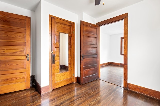 1006 W 1st St, Dixon, IL 61021 - spare room featuring dark wood-type flooring, baseboards, and ceiling fan