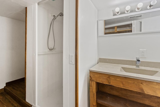 1006 W 1st St, Dixon, IL 61021 - full bathroom with vanity, a stall shower, and wood finished floors